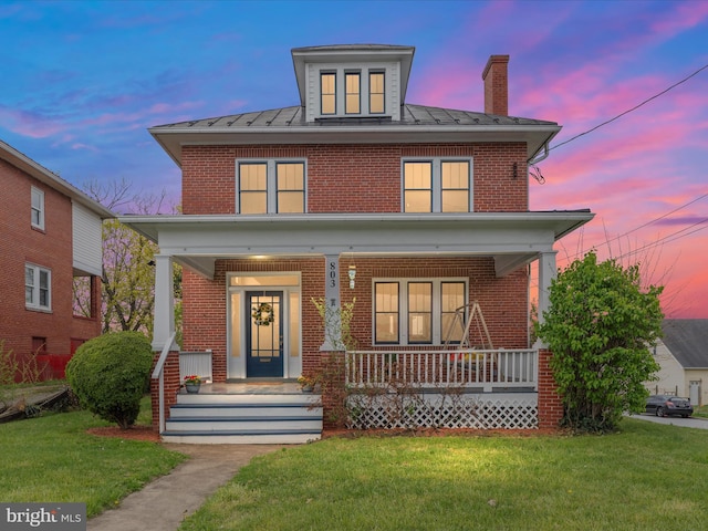 803 Berryville Ave, Winchester, VA 22601 - traditional style home with a chimney, brick siding, a front yard, and covered porch
