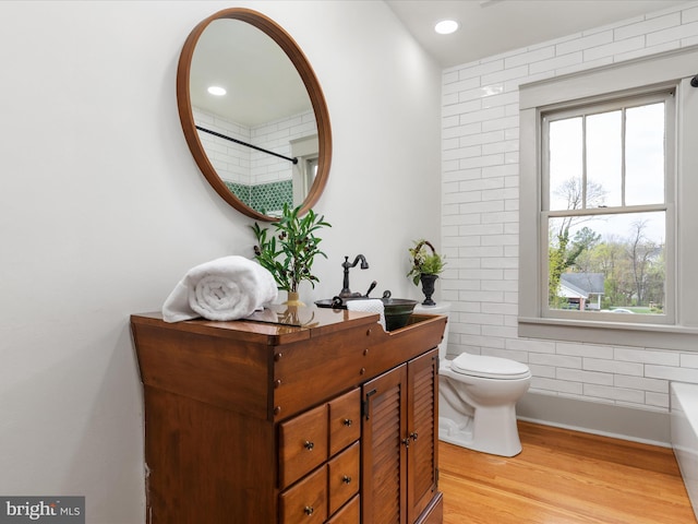 803 Berryville Ave, Winchester, VA 22601 - bathroom with wood finished floors, a wealth of natural light, toilet, and vanity