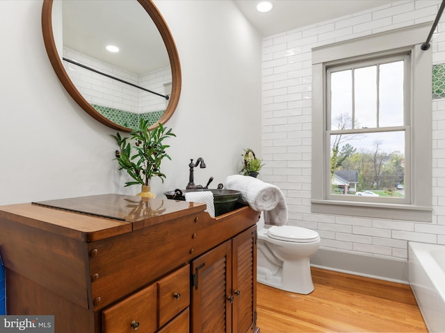 803 Berryville Ave, Winchester, VA 22601 - bathroom with a bath, vanity, recessed lighting, toilet, and wood finished floors