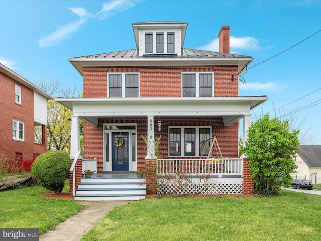 803 Berryville Ave, Winchester, VA 22601 - traditional style home featuring a standing seam roof, a porch, a front lawn, brick siding, and a chimney