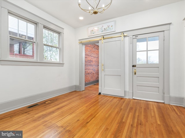 803 Berryville Ave, Winchester, VA 22601 - entrance foyer with a chandelier, a wealth of natural light, light wood finished floors, and baseboards