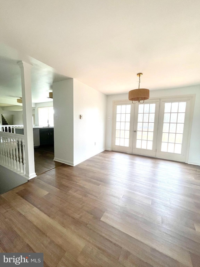 unfurnished room with wood finished floors and a healthy amount of sunlight