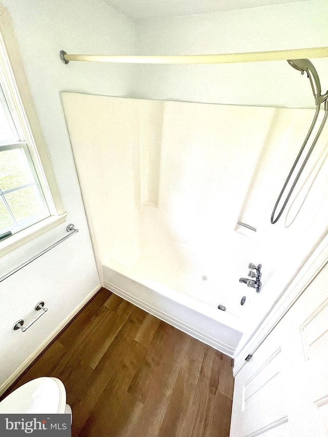 bathroom with toilet and wood finished floors