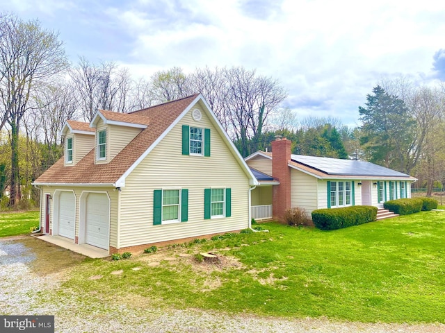 view of home's exterior with a shingled roof, a garage, driveway, and a lawn