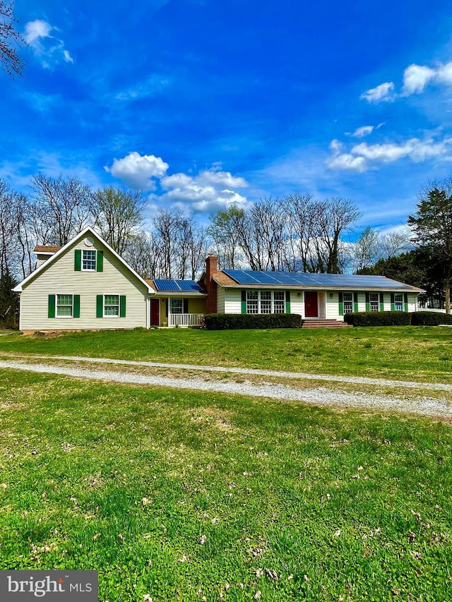 single story home featuring a front yard and a chimney