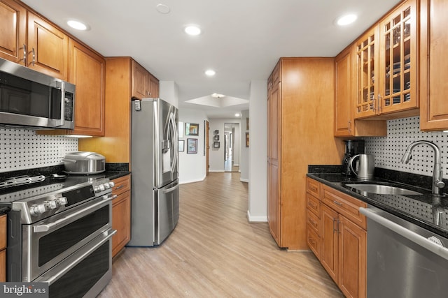 1530 Key Blvd Unit 528, Arlington, VA 22209 - kitchen featuring stainless steel appliances, a sink, decorative backsplash, light wood-style flooring, and recessed lighting
