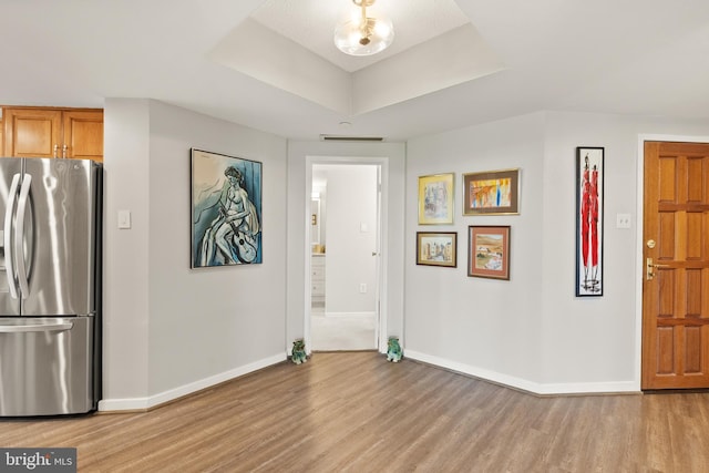 1530 Key Blvd Unit 528, Arlington, VA 22209 - entryway featuring light wood-style floors, baseboards, and a raised ceiling