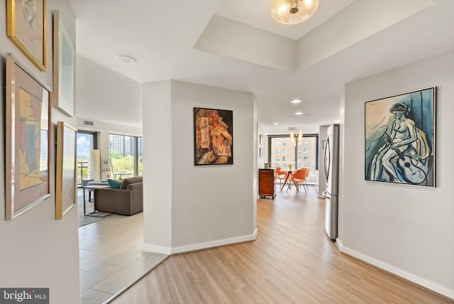 1530 Key Blvd Unit 528, Arlington, VA 22209 - hall featuring light wood-style flooring, baseboards, a chandelier, and recessed lighting