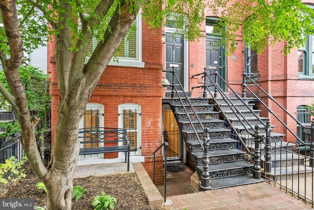 exterior space featuring fence and brick siding