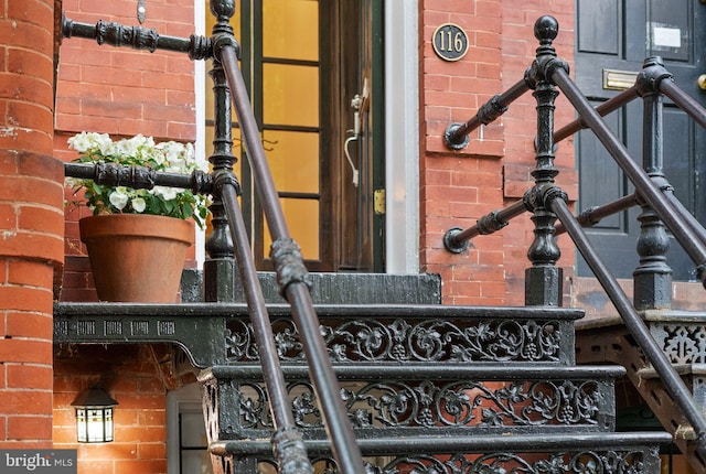 doorway to property with brick siding