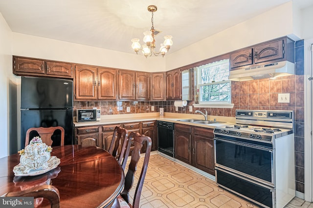 kitchen with a sink, a notable chandelier, light countertops, under cabinet range hood, and black appliances