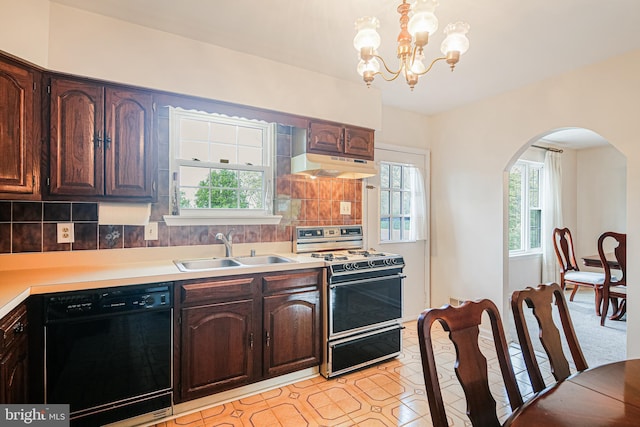 kitchen featuring range with gas stovetop, a sink, dishwasher, arched walkways, and under cabinet range hood