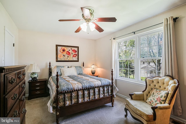 carpeted bedroom featuring a ceiling fan and baseboards