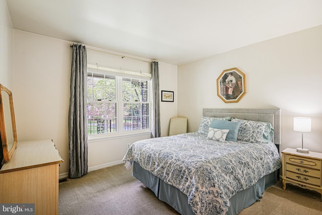 bedroom with carpet flooring and baseboards