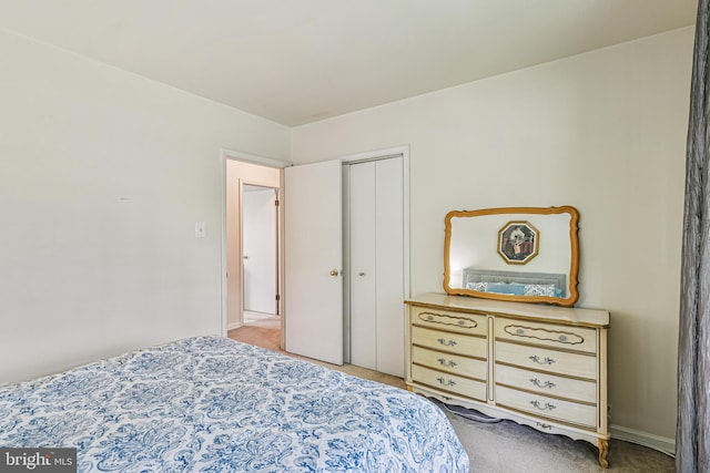 bedroom featuring light carpet and a closet