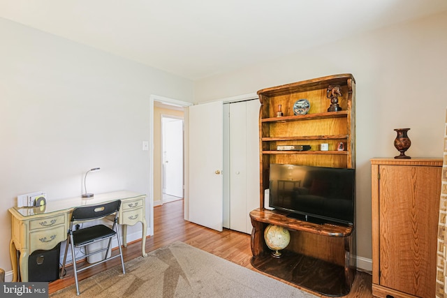 office with baseboards and wood finished floors