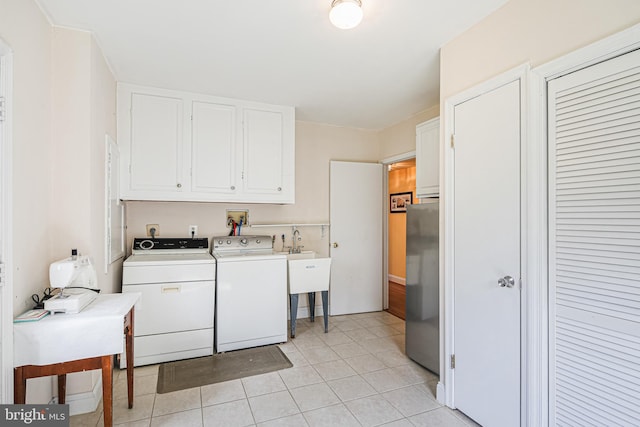 washroom featuring cabinet space, light tile patterned floors, and separate washer and dryer