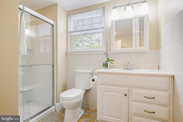 bathroom with tile patterned flooring, a shower stall, tile walls, and toilet