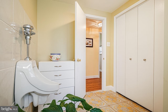bedroom with baseboards, a closet, and light tile patterned floors