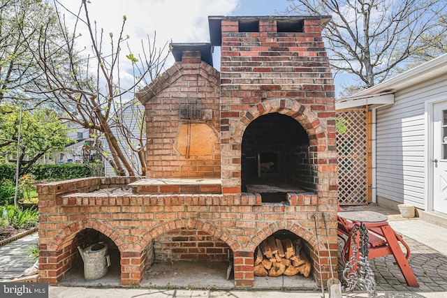 view of patio / terrace with an outdoor brick fireplace