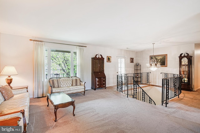 carpeted living room with baseboards and a notable chandelier