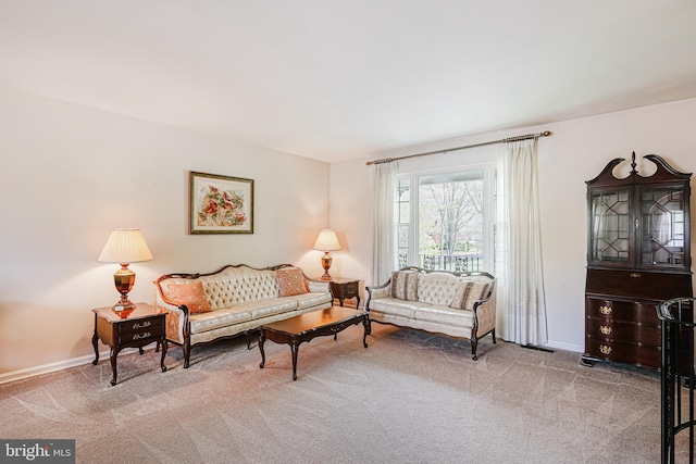 carpeted living area with visible vents and baseboards