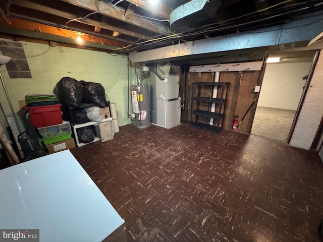 unfinished basement featuring tile patterned floors and water heater