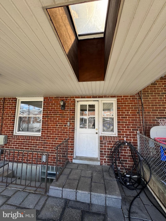 property entrance with brick siding