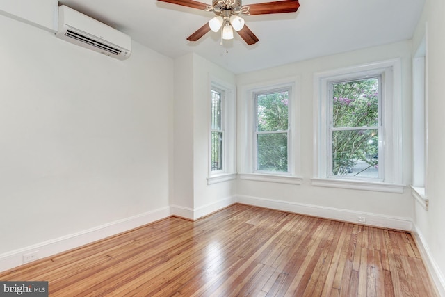 1674 Irving St NW, Washington, DC 20010 - empty room featuring baseboards, a wall mounted AC, plenty of natural light, and light wood-type flooring