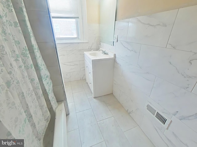 full bath with vanity, tile patterned floors, a shower with curtain, visible vents, and tile walls