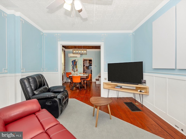 435S Market St, Frederick, MD 21701 - living room featuring a decorative wall, ceiling fan, a textured ceiling, ornamental molding, and wood finished floors
