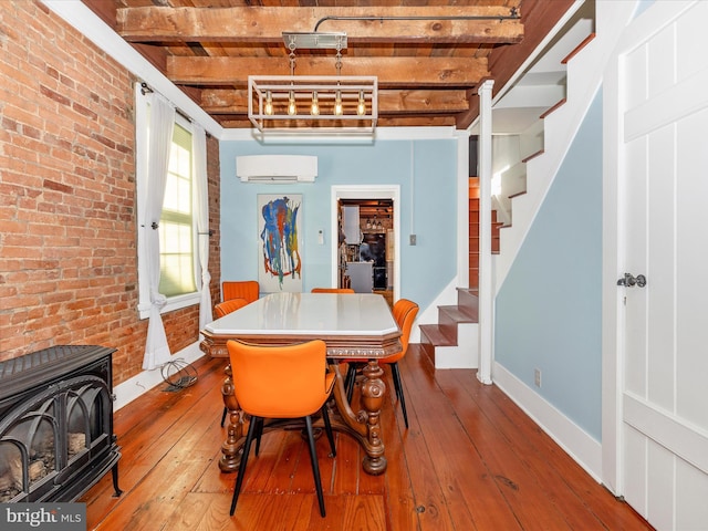 435S Market St, Frederick, MD 21701 - dining room with a wood stove, beamed ceiling, hardwood / wood-style floors, stairs, and brick wall