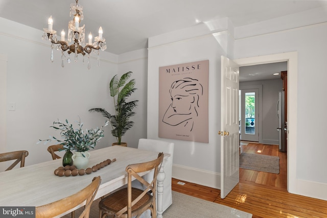 138 Charles St, Annapolis, MD 21401 - dining room with wood finished floors, a chandelier, and baseboards
