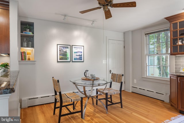 138 Charles St, Annapolis, MD 21401 - dining room with a baseboard heating unit, light wood-style floors, a ceiling fan, and rail lighting
