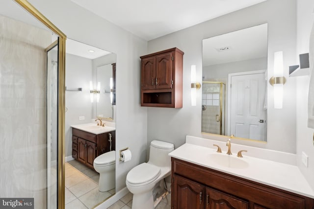 full bathroom featuring tile patterned flooring, toilet, vanity, baseboards, and a stall shower