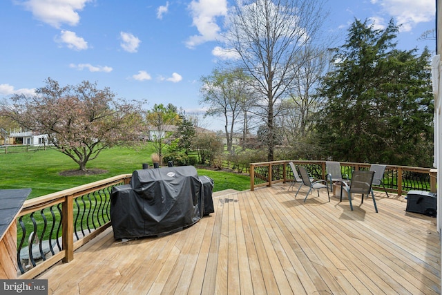 deck with grilling area and a yard