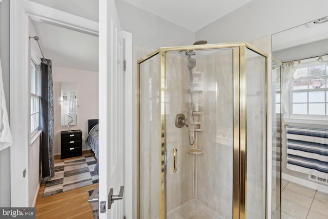 bathroom featuring a shower stall and ensuite bathroom