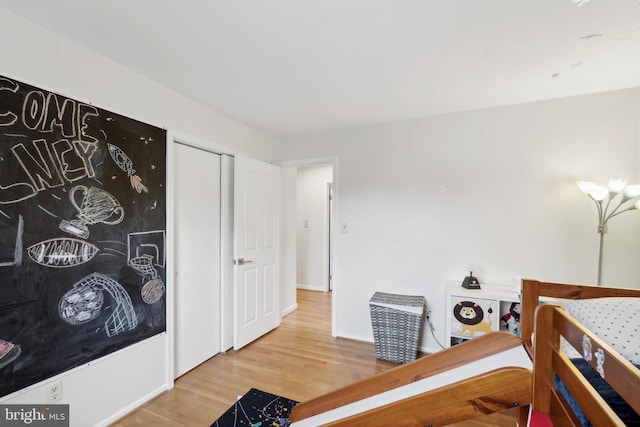 bedroom featuring wood finished floors and baseboards
