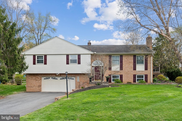 bi-level home with a chimney, brick siding, driveway, and an attached garage