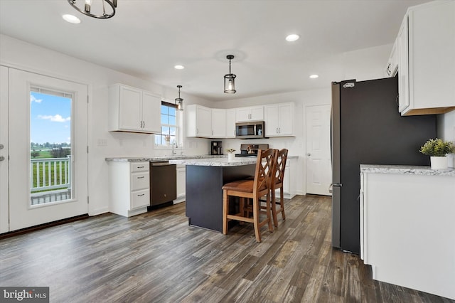 6301 Buchanan Trl W, Mercersburg, PA 17236 - kitchen with white cabinets, appliances with stainless steel finishes, dark wood finished floors, a kitchen island, and a breakfast bar area