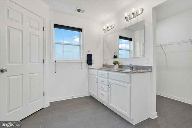 6301 Buchanan Trl W, Mercersburg, PA 17236 - full bathroom with a healthy amount of sunlight, double vanity, a sink, and baseboards
