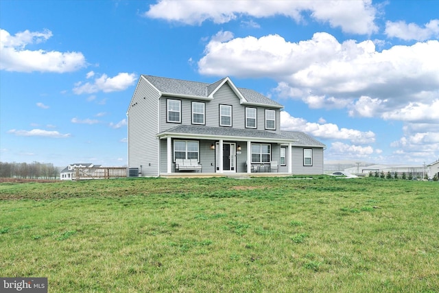 6301 Buchanan Trl W, Mercersburg, PA 17236 - traditional-style house with roof with shingles, central AC unit, a front lawn, and covered porch