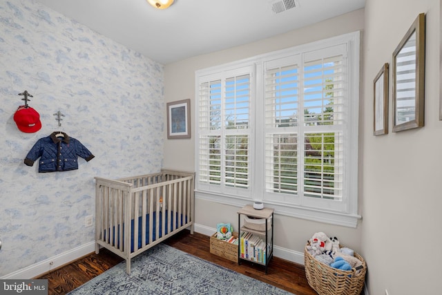 510 Quincy St NW, Washington, DC 20011 - bedroom featuring wallpapered walls, wood finished floors, baseboards, and visible vents