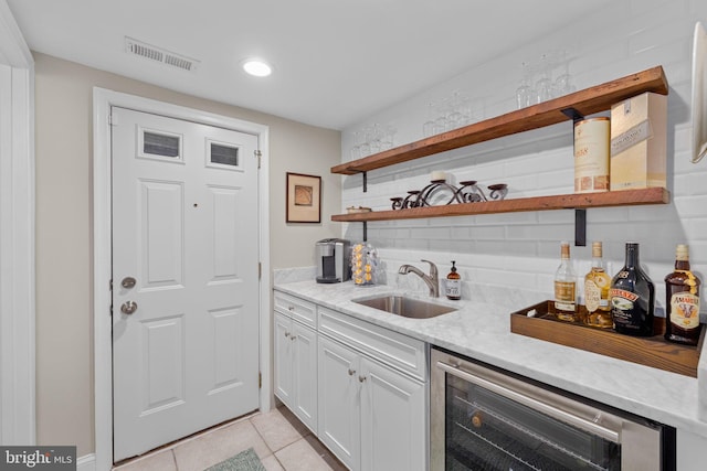 510 Quincy St NW, Washington, DC 20011 - bar with light tile patterned floors, wet bar, visible vents, a sink, and beverage cooler