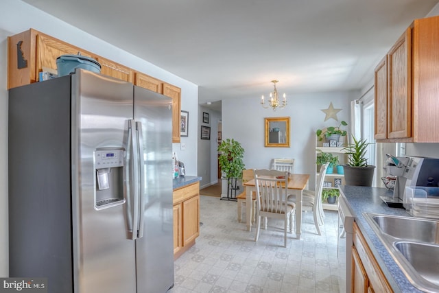103 N Spinnaker Ln, Milton, DE 19966 - kitchen featuring stainless steel refrigerator with ice dispenser, a chandelier, a sink, light floors, and pendant lighting