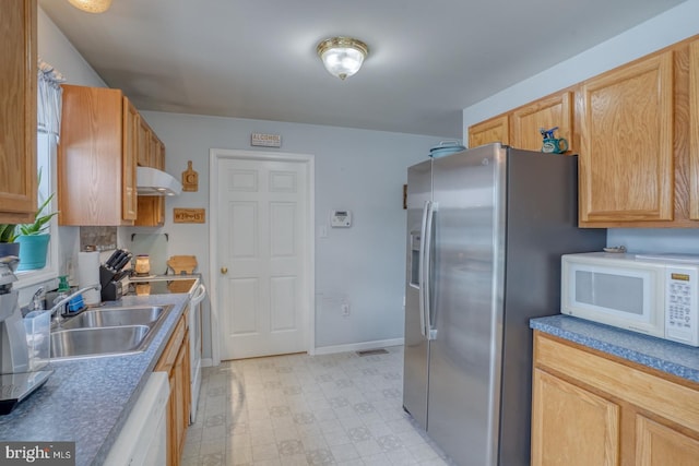 103 N Spinnaker Ln, Milton, DE 19966 - kitchen featuring white appliances, under cabinet range hood, a sink, light flooring, and baseboards