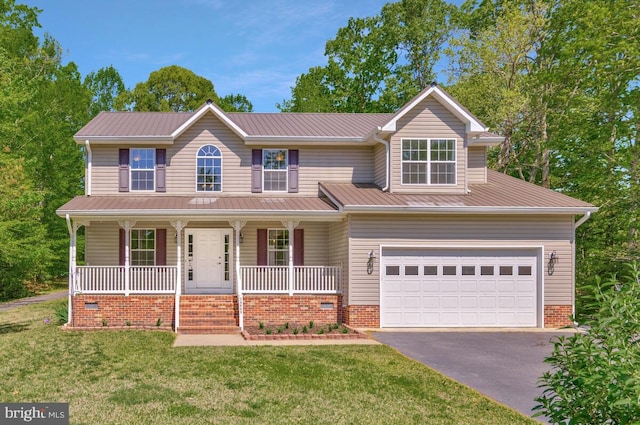 view of front of home with driveway, covered porch, a front yard, a garage, and metal roof
