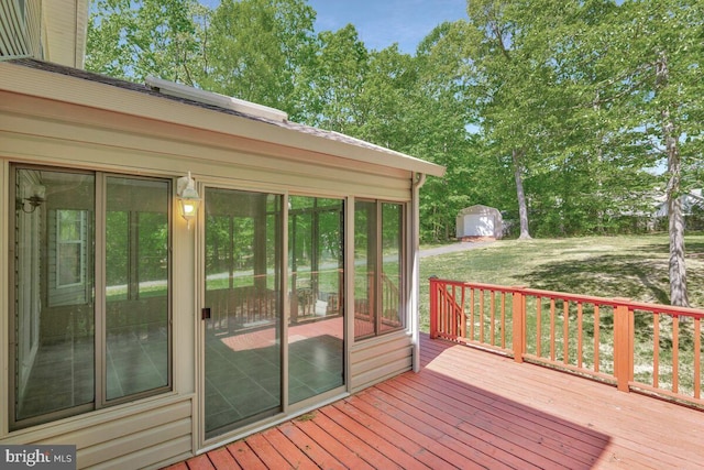 wooden terrace with view of wooded area