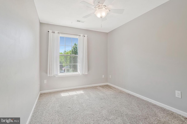 unfurnished room featuring carpet floors, baseboards, and a ceiling fan