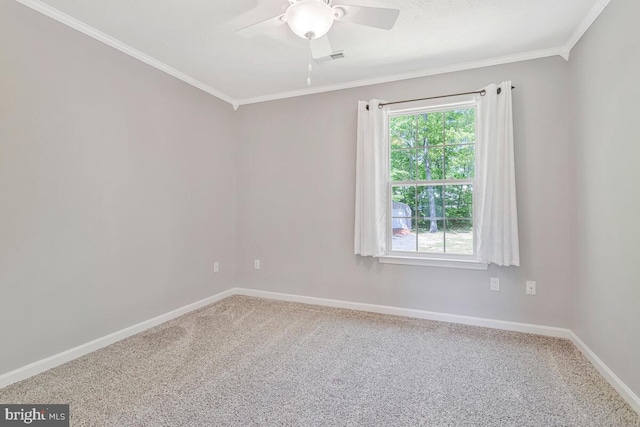 unfurnished room with carpet, crown molding, baseboards, and a ceiling fan